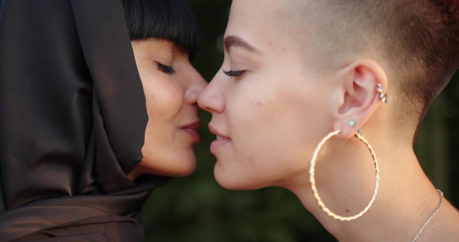 Young lesbian muslim woman in hijab kissing her girlfriend. | Shutterstock HD Video #1058708041