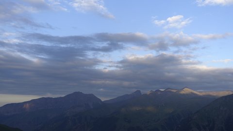 Silhouettes of mountains in the evening haze. Mountain ranges at sunset. Dusk. Time Lapse video.