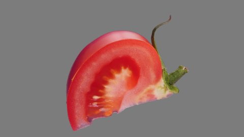 Fresh tomato slice spin and float - isolated on neutral gray. Seamless loop for unlimited duration. luma matte included for compositing projects. 