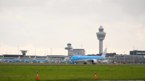 AMSTERDAM - AUGUST 15, 2019: KLM Royal Dutch Airlines Boeing 787-9 Dreamliner pull by tractor from terminal. Ground movement at Schiphol airport, passenger plane departure, taxiing to runway