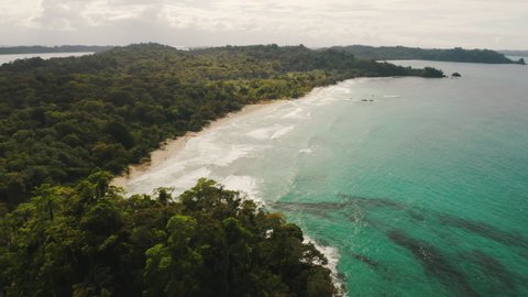 Beautiful aerial drone view of Island coast with white sand, turquoise sea and forest in Panama, Bocas del Toro