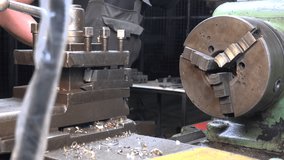 Video of a engineer working with metal details on a lathe
