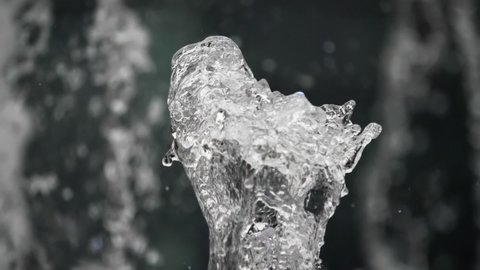 The water in the fountain splashes against a black background. Splash in slow motion.
The water in the fountain splashes against a black background.