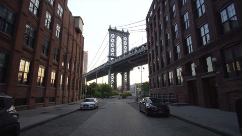 Brooklyn Bridge View from Dumbo Empty Neighborhood Street with Brick wall Apartment Buildings at Sunrise with no people Circa May 2018