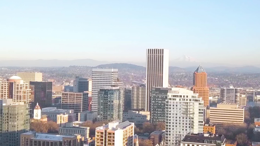 Aerial dolly zoom with a panoramic view of Portland, Oregon, USA and Mount Hood covered in snow in the far distance. Bird