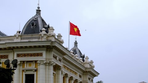 Hanoi Opera House rooftop with the Vietnamese Flag waving, located on the Square of August Revolution, Locked close-up shot