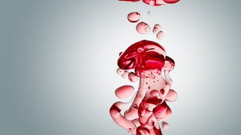 transparent red oil bubbles and fluid shapes in purified water on a white gradient background. Side angle with crystal colored bubbles in water cosmetic backdrop with copy space
