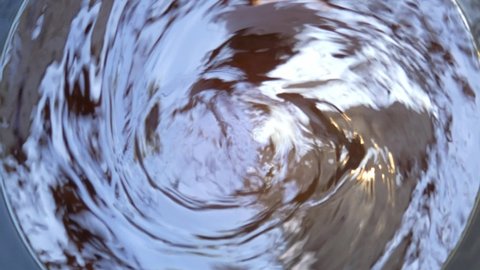 Moving Water spins into a whirlpool, Top view Out of focus.