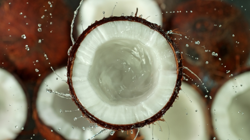 Super Slow Motion Shot of Splashing Water from Coconut at 1000fps. Royalty-Free Stock Footage #1058754196