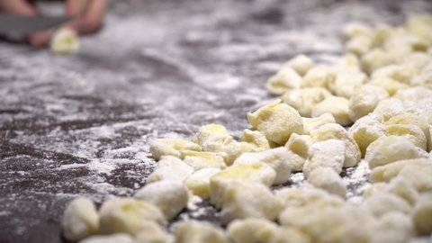 Slicing the dough with a knife to cook gnocchi