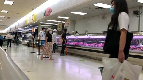 burnaby , bc / Canada - 08 21 2020: Burnaby, BC, Canada - August 21, 2020 : Motion of customer line up for buying meat inside T&T Chinese supermarket with 4k resolution