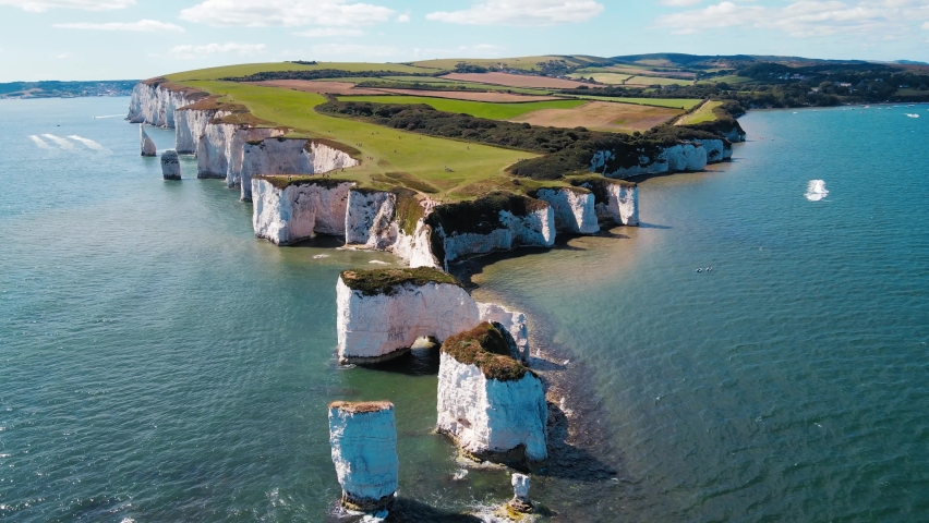 ENGLAND, Beautiful aerial footage over the white cliffs, Old Harrys Rocks on the south coast of England. Royalty-Free Stock Footage #1058761366