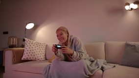 Overjoyed Pretty Southeast Asian Woman Playing Video Games On A Console And Winning
