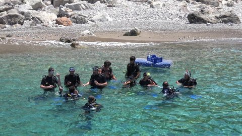 Fethiye, Turkey - 30th of July 2020: 4K Group of students having scuba diving practice courses in soundings
