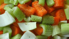 Closeup of putting pepper raw vegetables, slices of carrots and celery before baking. 