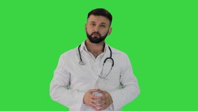 Confident doctor talking and looking into the camera on a Green Screen, Chroma Key.