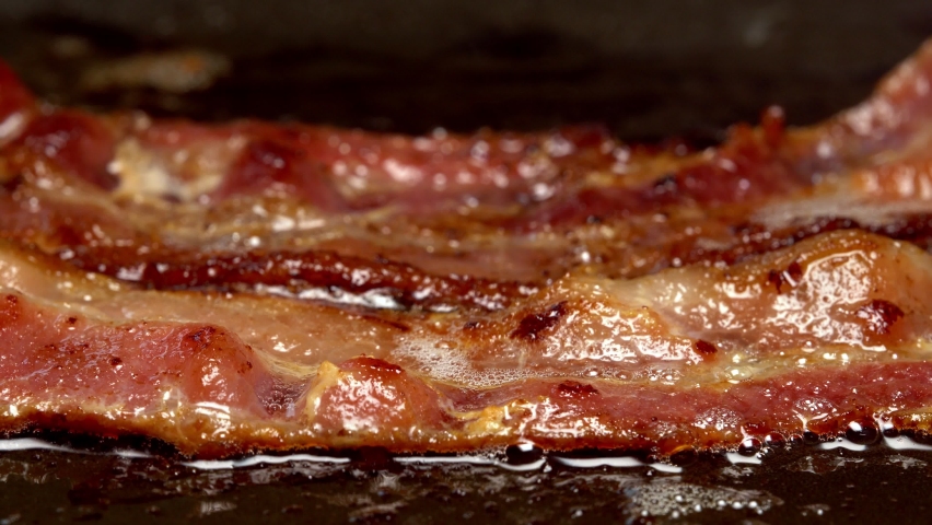 Close-up view of bacon slices in frying pan. Royalty-Free Stock Footage #1058773279