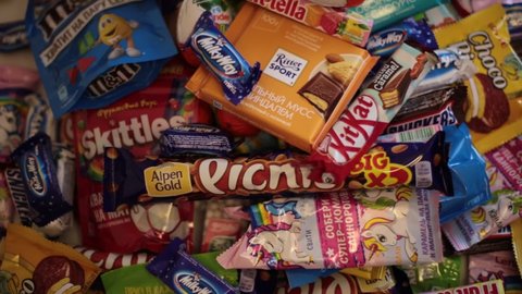 Nizhny Novgorod, Russia - September 3, 2020: Lots of popular sweets: Halls, Snickers, tic tac, Picnic, Orion, KitKat, Skittles, M&Ms, Ritter Sport, Choco Pie, Natoons, Kinder, Mamba, Milky Way, Bounty