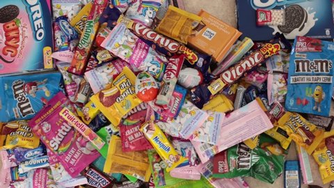 Nizhny Novgorod, Russia - September 3, 2020: Lots of popular sweets: Halls, Snickers, tic tac, Picnic, Orion, KitKat, Skittles, M&Ms, Ritter Sport, Choco Pie, Natoons, Kinder, Mamba, Milky Way, Bounty