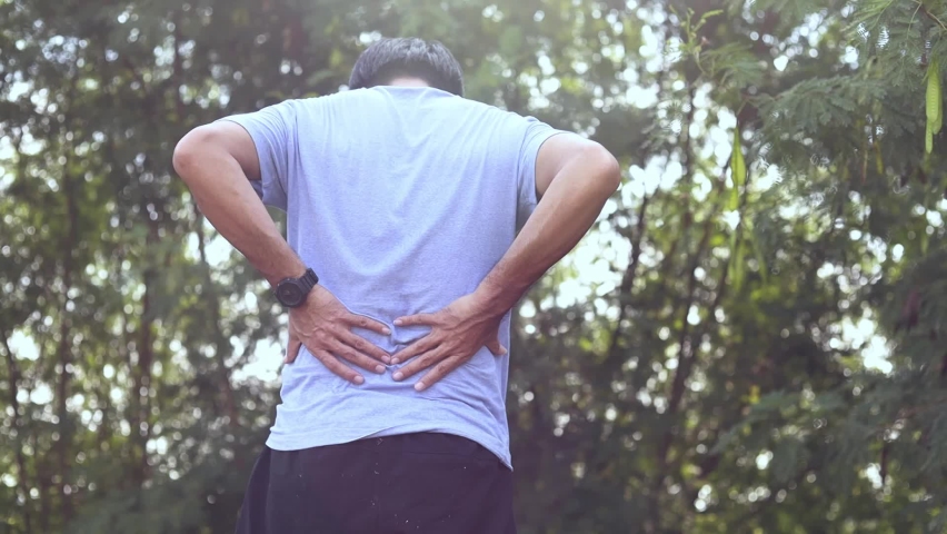 Young Asian man feels pain on her back exercising, health care concept. Royalty-Free Stock Footage #1058778763