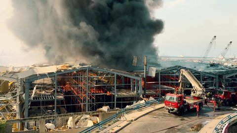 Beirut Port / Lebanon - 9 10 2020: Big Fire and dark Smoke in Beirut Port one month after the Blast | Firemen and rescue teams working to extinguish the flames