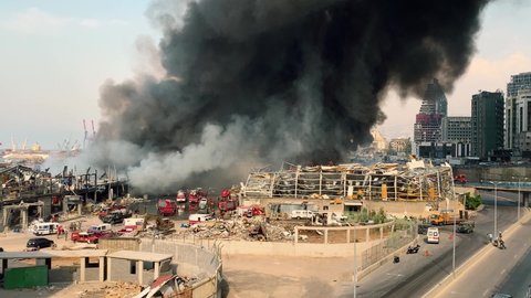 Beirut Port / Lebanon - 9 10 2020: Big Fire and dark Smoke in Beirut Port one month after the Blast | Firemen and rescue teams working to extinguish the flames