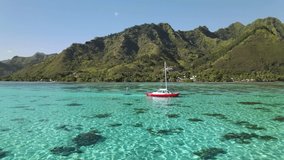 Aerial view, drone shot 4k. Sailboat in ocean, Moorea coastal landscape of Tahiti, French Polynesia. Tropical paradise. Exotic travel vacation getaway, romantic honeymoon destination.