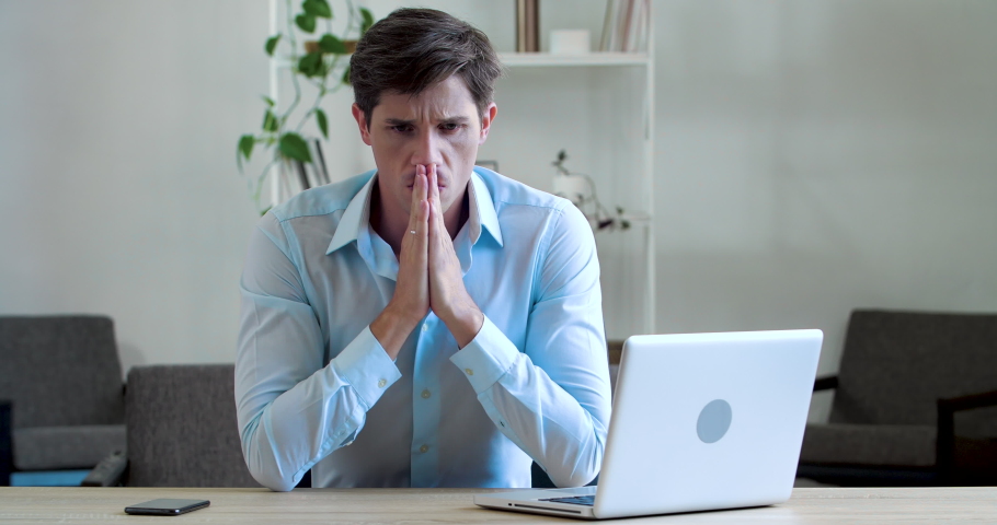Frustrated young business man feels headache illness, soreness, thinks about difficult problem, worries about bad news or losing money, stress of hard work, fails sitting at table in office workplace Royalty-Free Stock Footage #1058787460