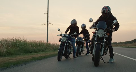 A group of bikers gets on motorcycles and starts the journey