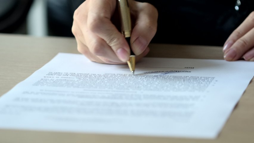 Signature on Contract by Pen in Female Hand. Close-up of Businesswoman Hands Putting Signature on Paper. Signs an Agreement. Close-up Macro Shot. Signature Is Fake Royalty-Free Stock Footage #1058790430