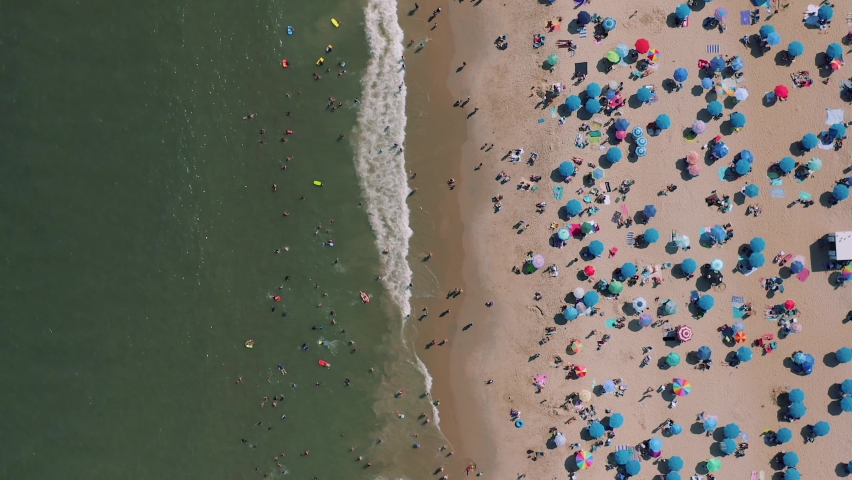 This 4k video shows many people at Rehoboth beach Delaware during the Labour Day weekend. People are having some fun time at beach and swim at sea water.