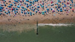 This 4k video shows many people at Rehoboth beach Delaware during the Labour Day weekend. People are having some fun time at beach and swim at sea water.