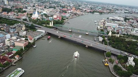 Bangkok Thailand Water and Bridge Traffic Aerial. Phra Pokklao and Memorial Bridges Over Chao Phraya River and King Rama Monument Park