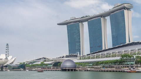 SINGAPORE - CIRCA JAN 2020: Fifty-five storeys high Marina Bay Sands Hotel dominates the skyline at Marina Bay in Singapore timelapse hyperlapse. Art Science museum and ferris wheel