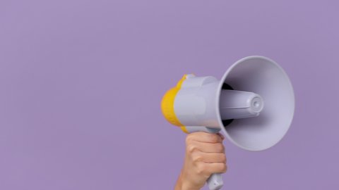 Close up cropped woman hold in hand bullhorn public address megaphone isolated on purple violet background studio. Hot news announce discounts sale hurry up communication concept. Copy space mock up