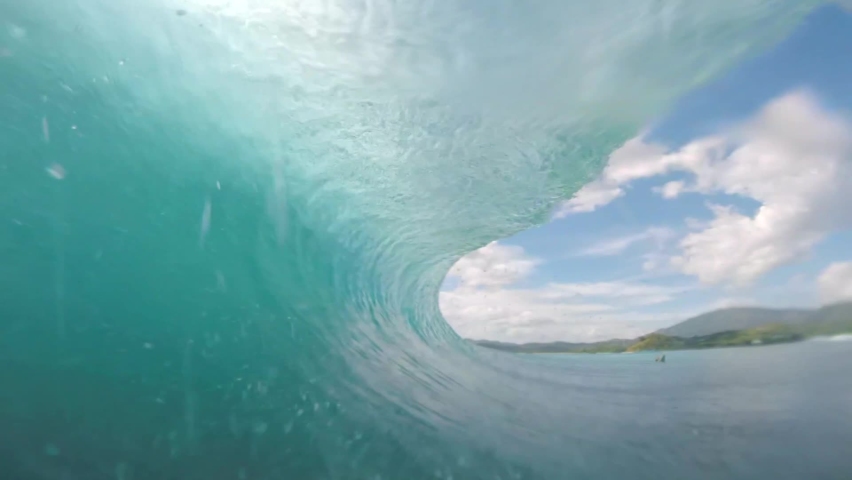 Vision from the inside of a perfect wave surfing the tube