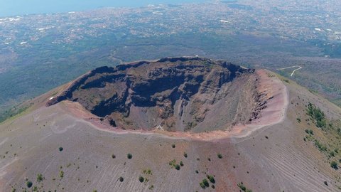 Aerial view of volcano Mount Vesuvius, rough volcanic terrain inside crater on top of mountain - landscape panorama of Naples from above, Italy, Europe