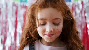 Girl In Party Hat Celebrating At Birthday Party Blowing Handful Of Gold Confetti And Glitter - Powered by Shutterstock - Get 15% off with code: PIKWIZARD15