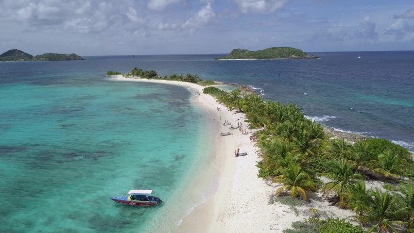 Aerial drone shot along Sandy Island Beach, Carriacou, Grenada, West Indies, Caribbean, Central America | Shutterstock HD Video #1058825497