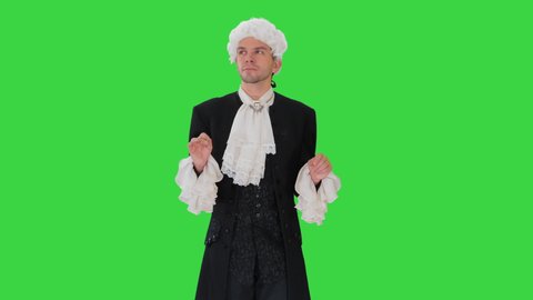 Man dressed in courtier frock coat and white wig thinking and fidgeting with his fingers on a Green Screen, Chroma Key.