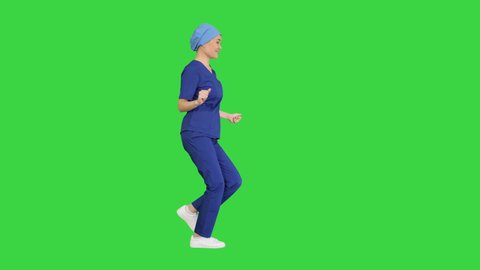Girl doctor is dancing and walking on a Green Screen, Chroma Key.