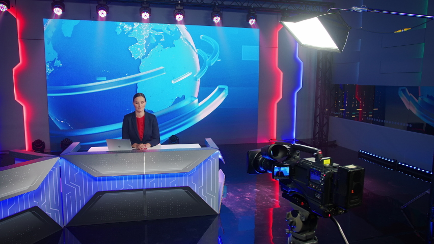 Live News Studio with Beautiful Female Anchor Reporting on the Events of the Day. TV Broadcasting Channel with Professionals Presenter, Newscaster, Reporter Talking. Mock-up Television Newsroom | Shutterstock HD Video #1058828638
