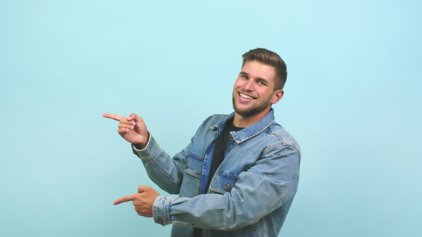 Young caucasian handsome man pointing to the side, smiling surprised presenting something, natural and casual