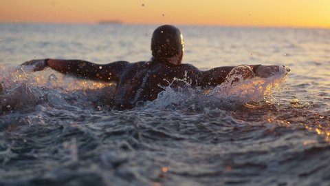 Professional Swimming Workout at Sunset, an athlete Swimming Preparing for Competition. Professional Swimmer Workout In Open Water. Swimmer Sport Exercising. High quality 4k footage