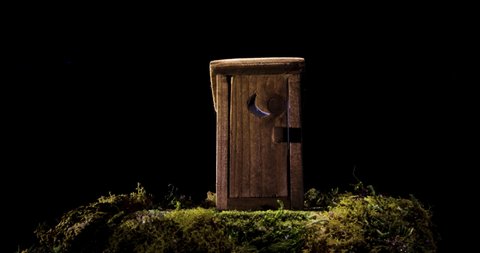 Outhouse bathroom shed miniature model motion slider shot in 4k against black background