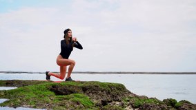 beautiful young woman in swimsuit have exercises workout at the beach enjoying nature and fitness lifestyle. High quality 4k footage