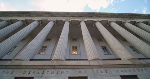 Washington D.C. / United States - August 26 2020: The Department of the Treasury building. Pan down building to name and seal on Westside entrance  of The United States Department of the Treasury. 