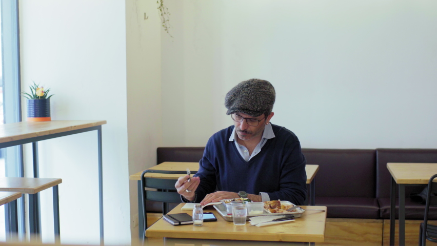 Man writing in restaurant, Turin, Italy