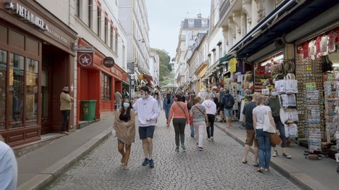 Paris , Ile De France / France - 09 09 2020: Shot of Tourists Wearing Mask and Walking in The Street Of Montmartre During the Coronavirus Pandemic, Paris France