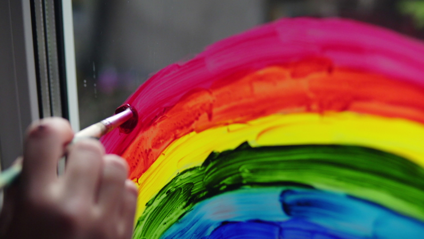 Painting a rainbow with paints on a window close-up | Shutterstock HD Video #1058851645